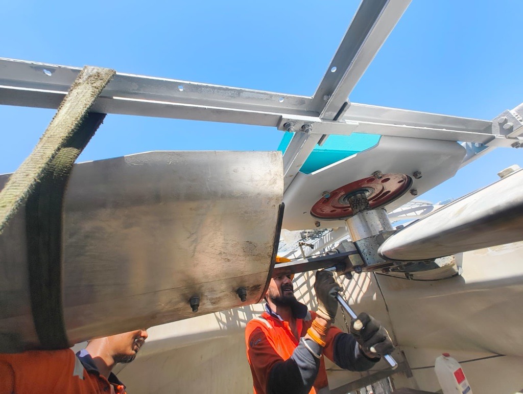 Servico technicians servicing rooftop mechanical equipment